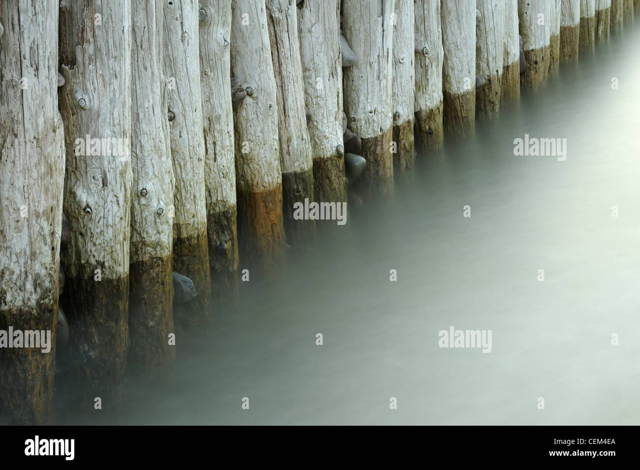 Wooden groynes and blurred water, Bossington beach, Somerset, UK Stock Photo