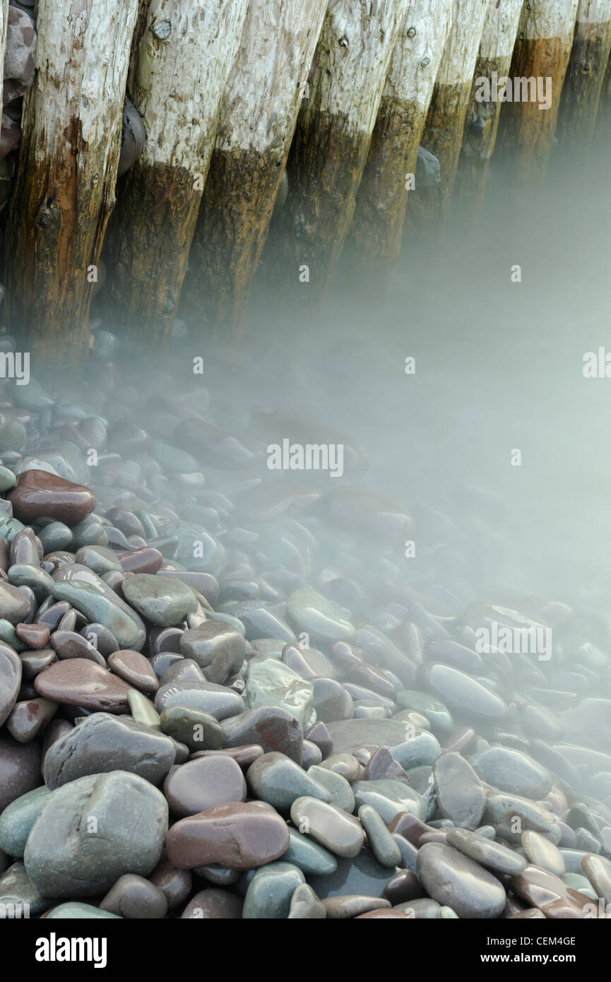 Wooden groynes and blurred water, Bossington beach, Somerset, UK Stock Photo