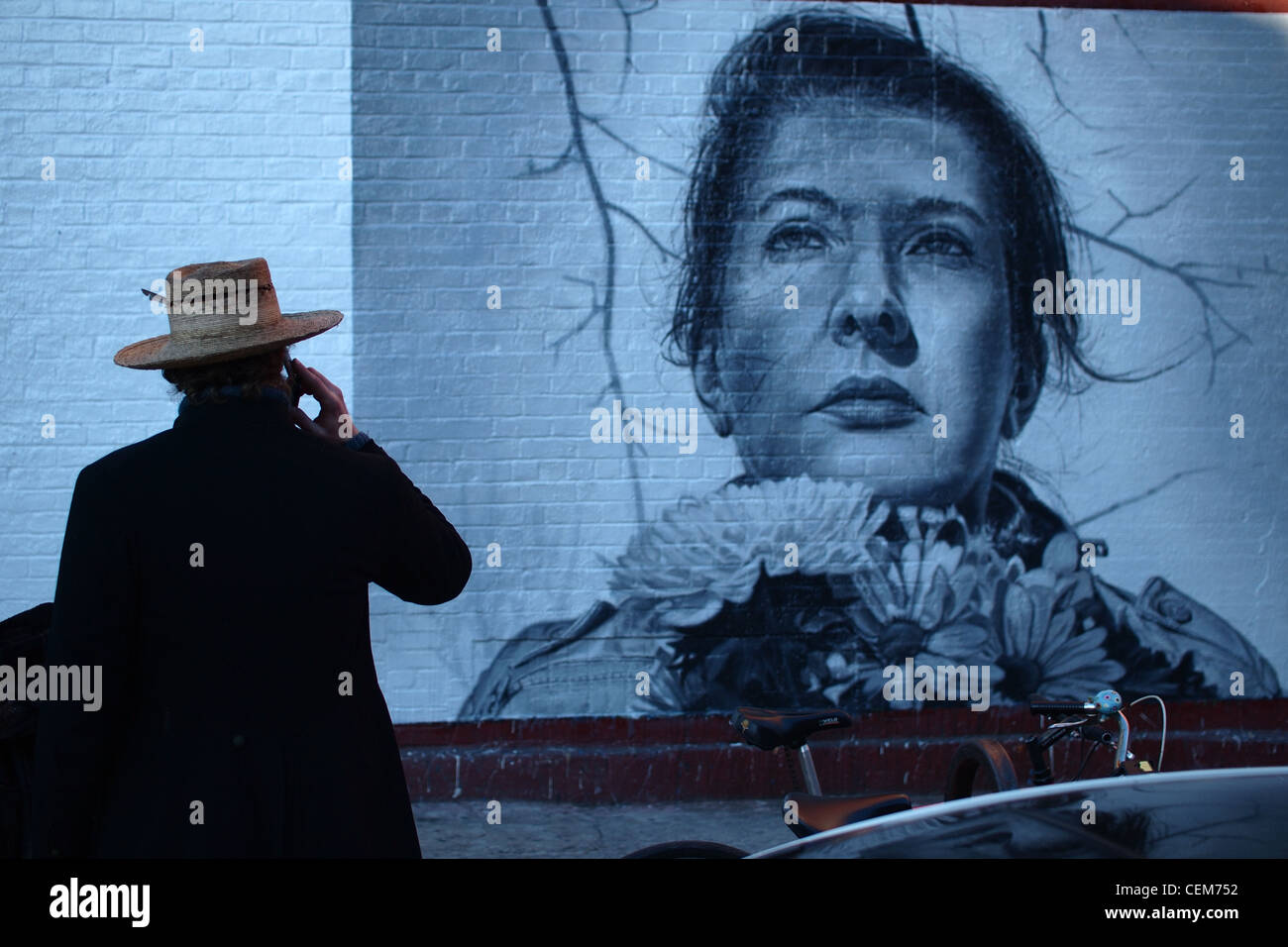 Man standing in front of mural of artist Marina Abramovic, Brooklyn, New York Stock Photo