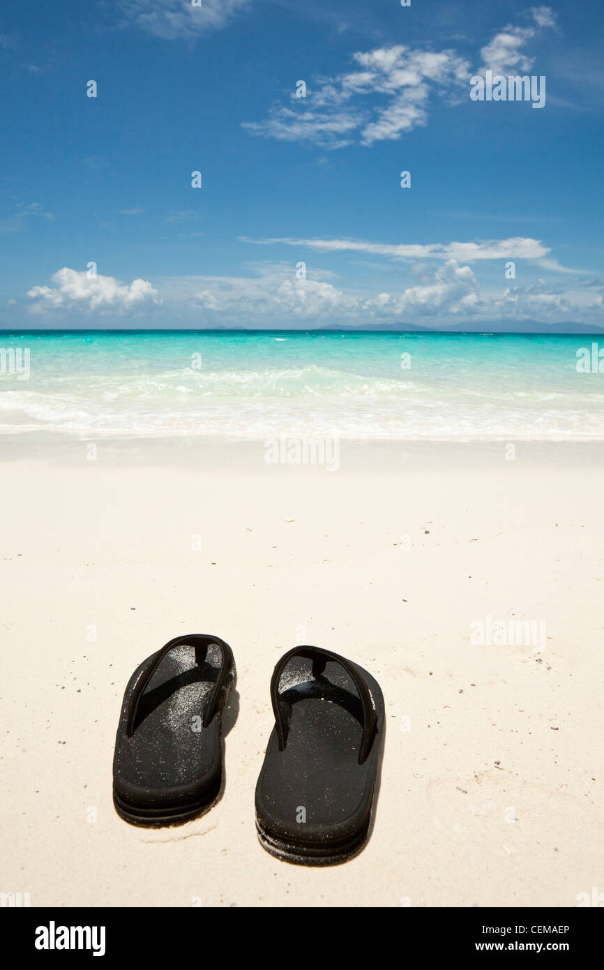 Flip flops on the shore of Vlassof Cay - a remote sand cay near Cairns. Great Barrier Reef Marine Park, Queensland, Australia Stock Photo