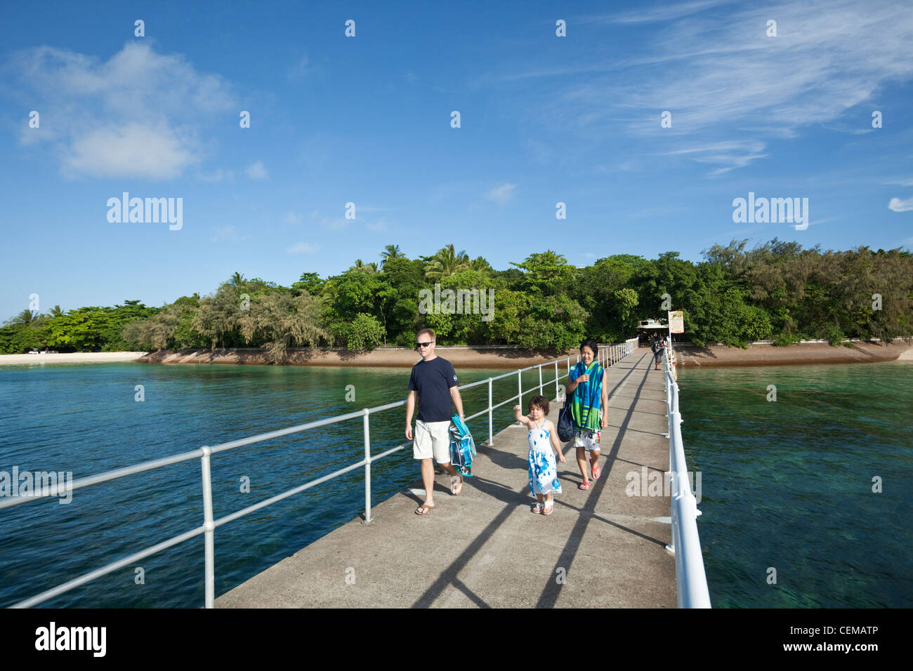 Family walking along jetty at Green Island.  Great Barrier Reef Marine Park, Queensland, Australia Stock Photo