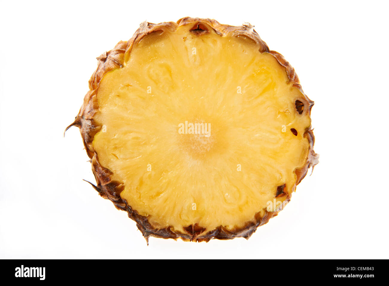 Overhead view of slice of pineapple on plain background Stock Photo
