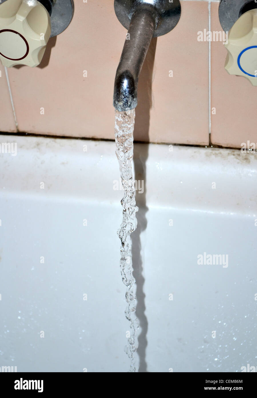Running water in dirty bathtub Stock Photo