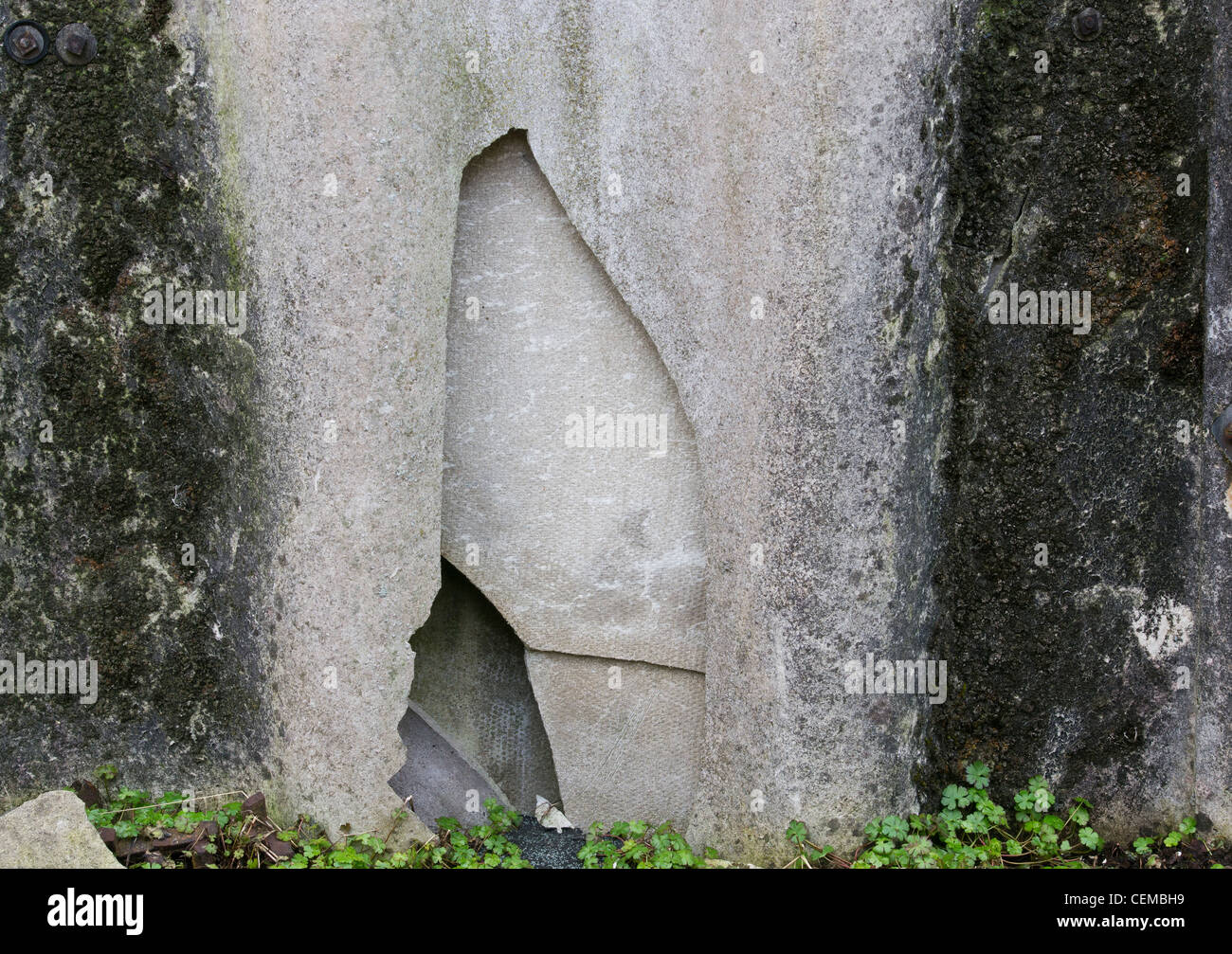 Broken asbestos sheeting covering a disused factory building. Stock Photo