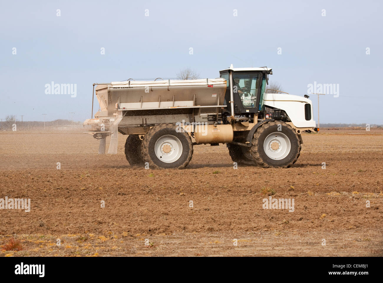 Agriculture A New Leader spreader applies dry fertilizer to a bedded
