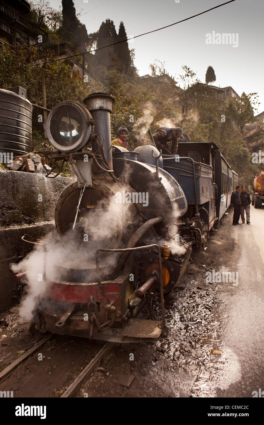 India, West Bengal, Darjeeling Himalayan Mountain Railway steam train taking on water Stock Photo