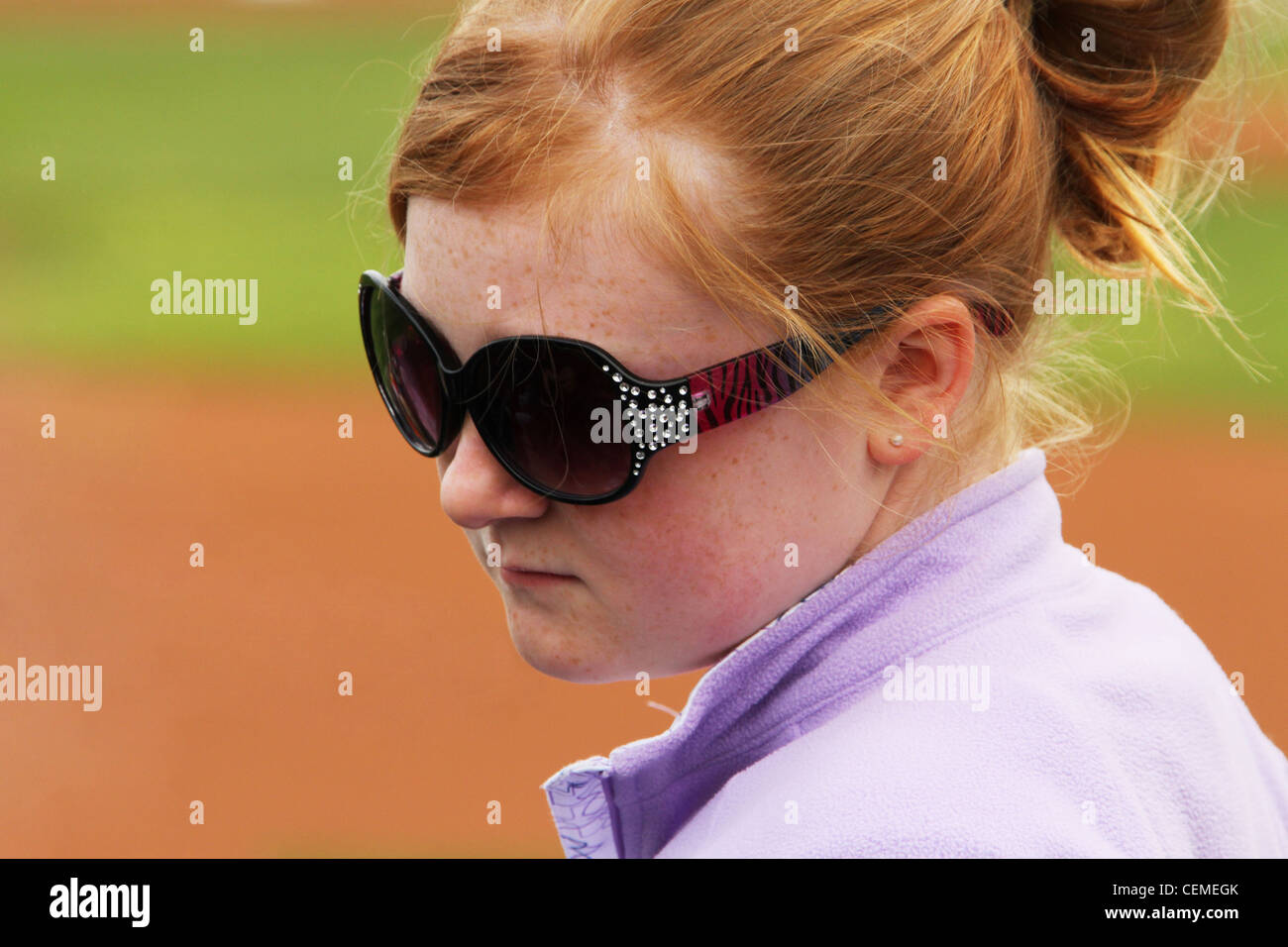 Red Hair Girl with Freckles and Sunglasses. Scenes of the Dayton Dragons Baseball game. Dayton, Ohio, USA. Stock Photo