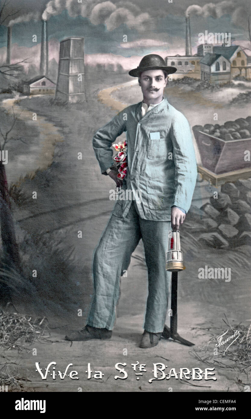 France, circa 1910, a miner standing outside of a coal mine holding a bouquet of flowers, a lantern and a pick ax. Stock Photo