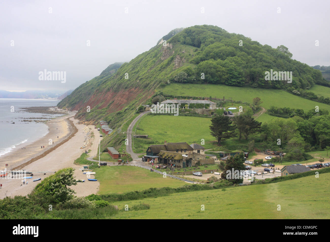 Brandscombe beach devon uk, mist in the early morning, rolling in from the sea,south devon,summer holidays boats on beach,beach Stock Photo