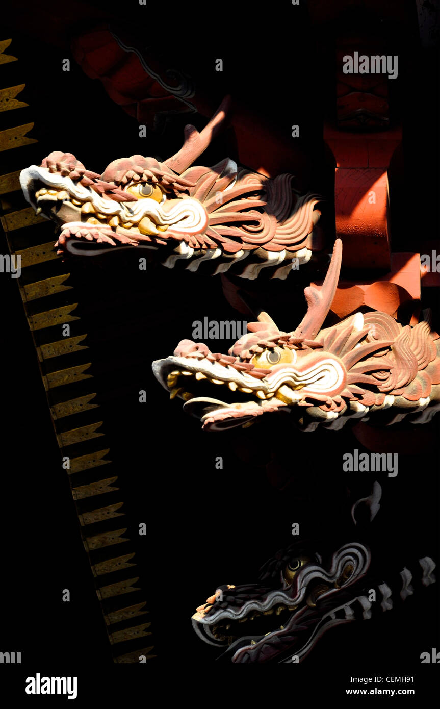 Carved wooden dragons emerging from the darkness in a Japanese Temple