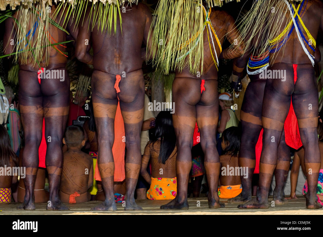 The men of the Embera people have full body tattoos, and watch a dance in their village, Darien Jungle, Panama Stock Photo