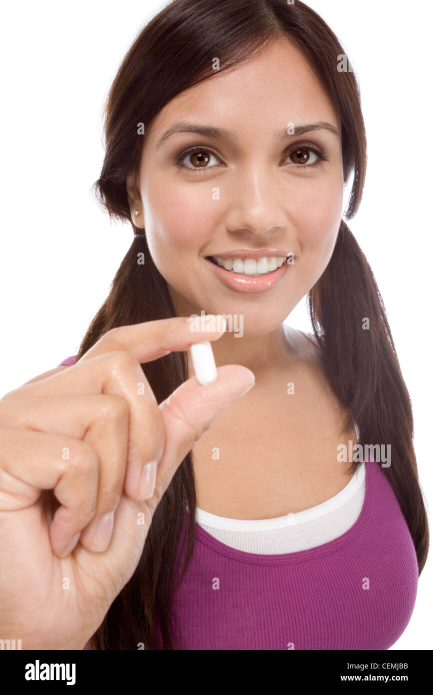 Young Latina woman showing white medication tablet Stock Photo