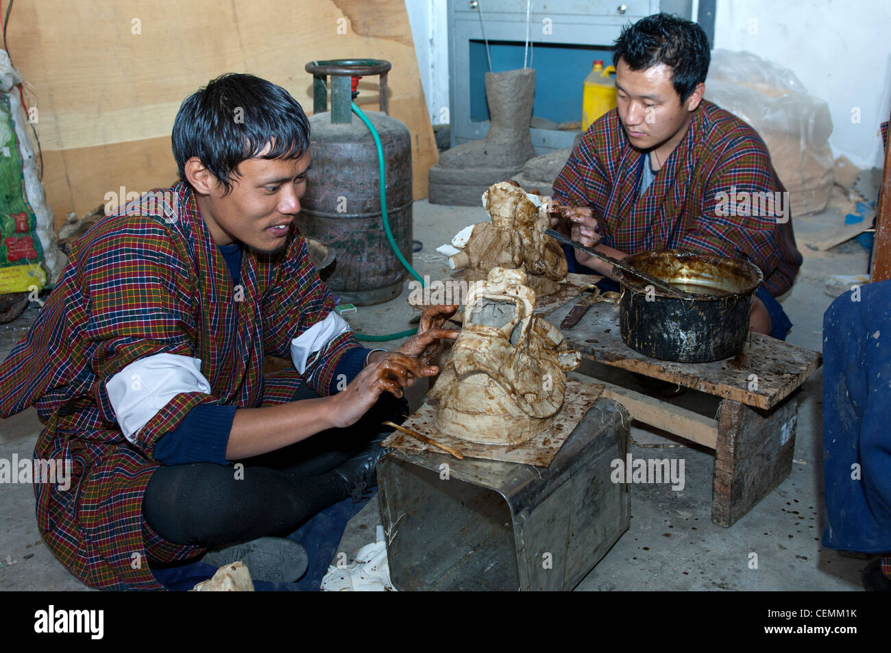 Bhutanese student artists producing masks, National Institute for traditional arts and crafts Zorig Chusum, Thimphu, Bhutan Stock Photo