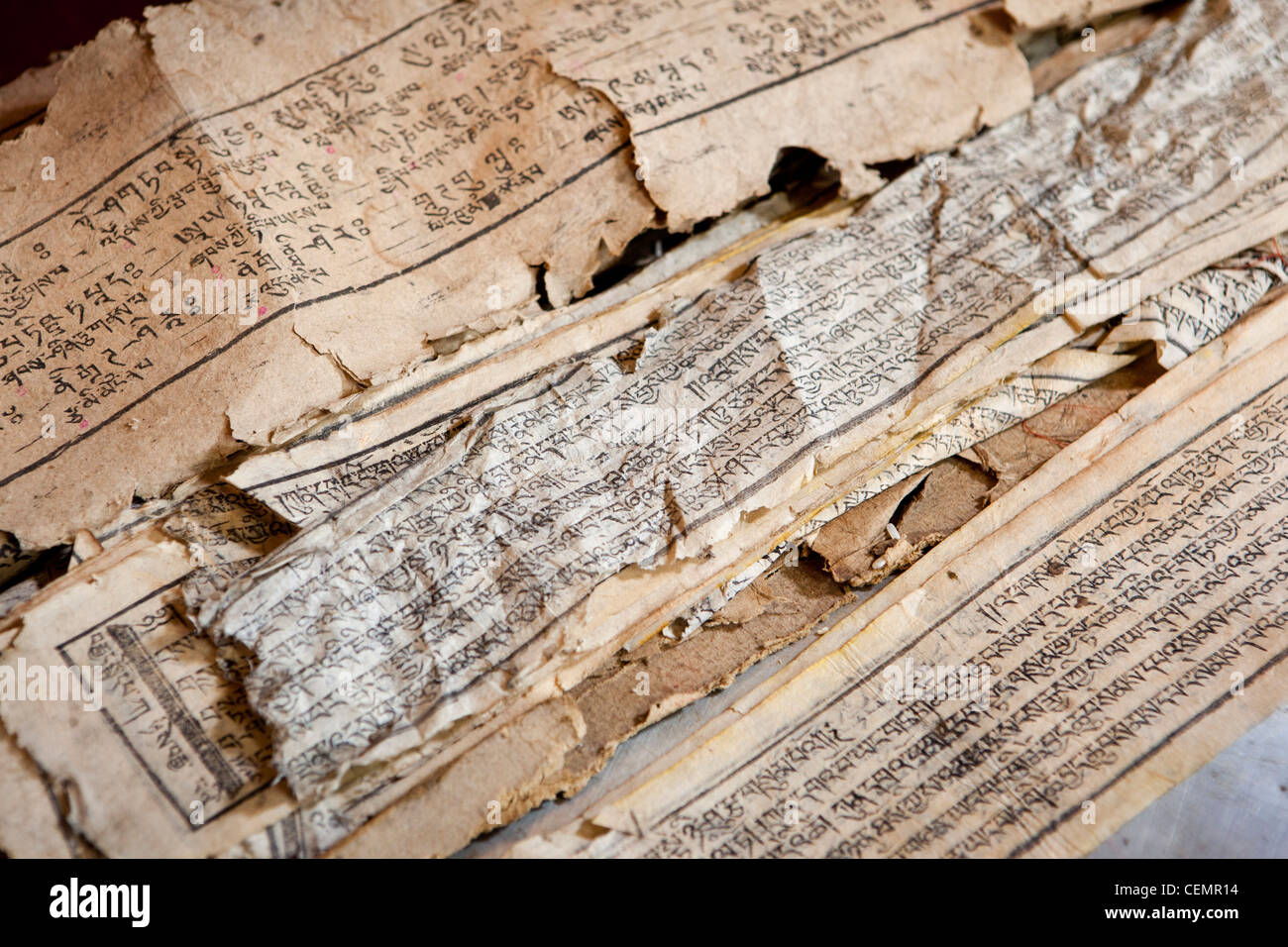 India, West Bengal, Ghoom, Yiga Choeling Monastery printed Buddhist texts worn through repeated handling Stock Photo