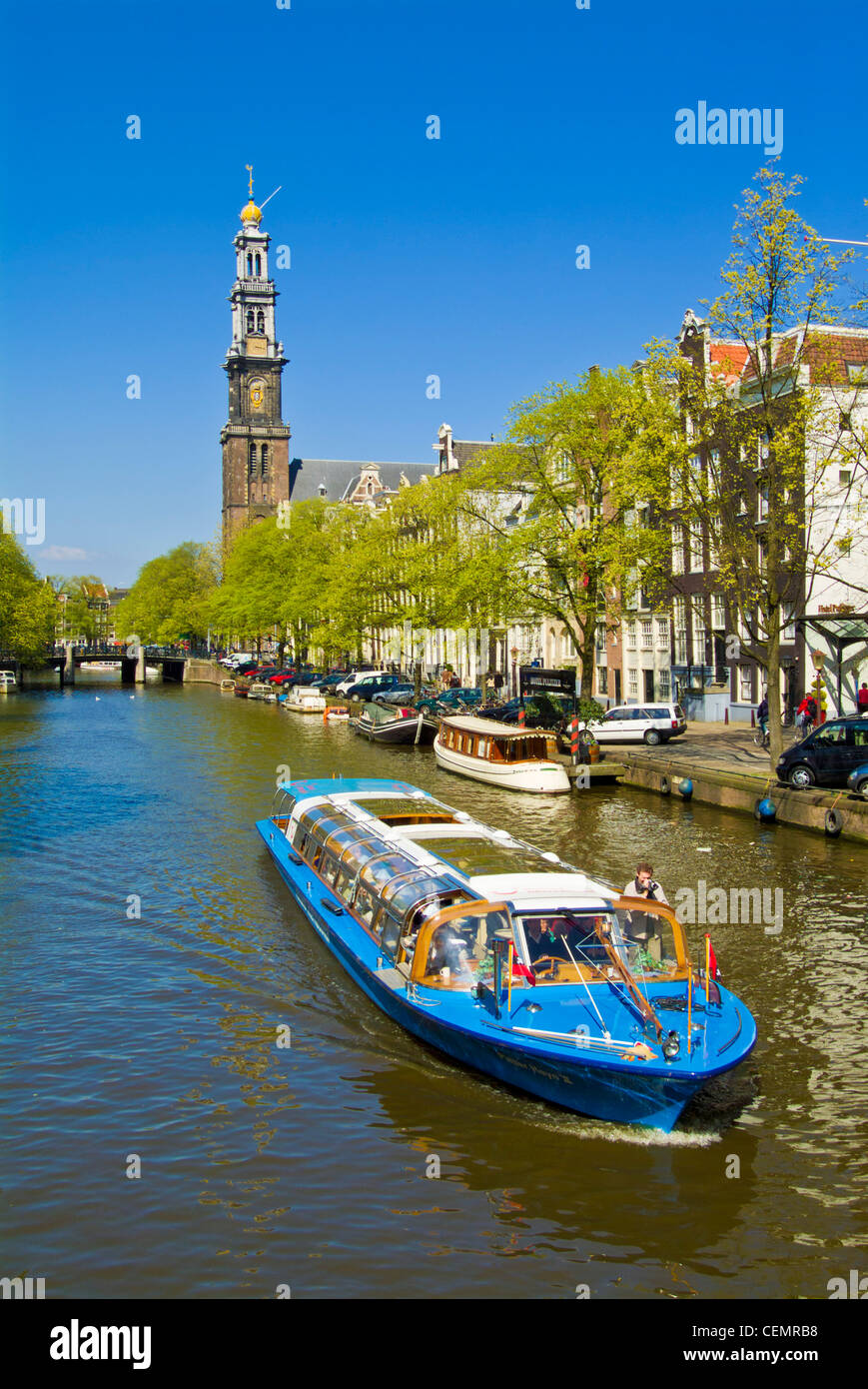 Cruise boat on Prinzengracht canal near the Westerkerk central Amsterdam Netherlands Holland EU Europe Stock Photo
