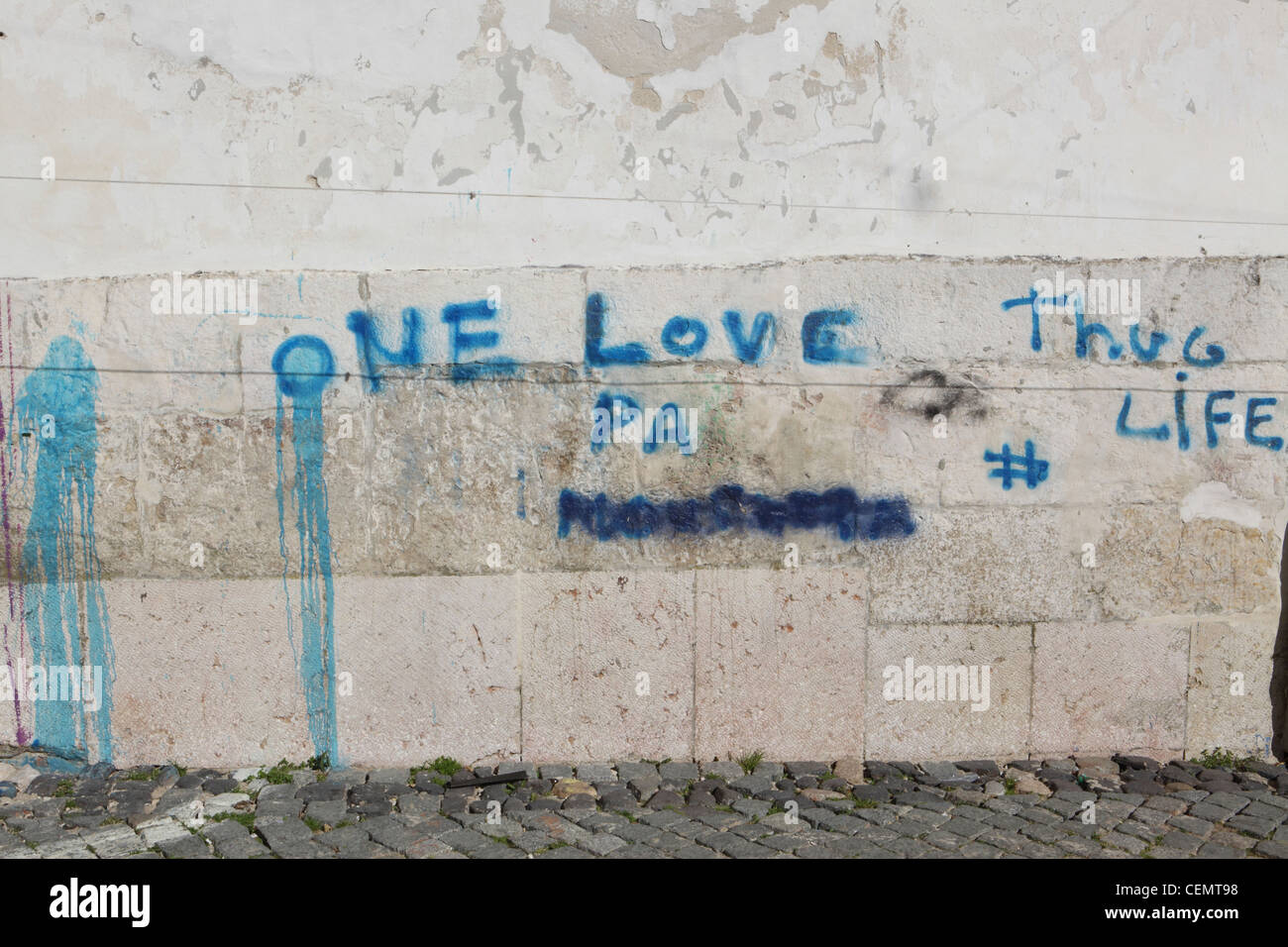 'One Love', 'Thug Life', blue painted graffiti on wall in Lisbon, Portugal, European Capital city. Stock Photo