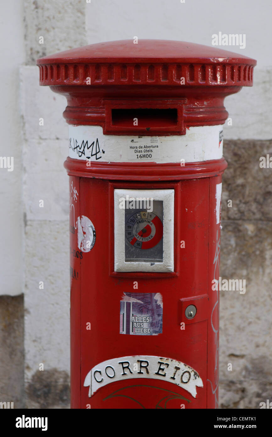 Red traditional old fashioned letterbox postal service Lisbon, Portugal Stock Photo