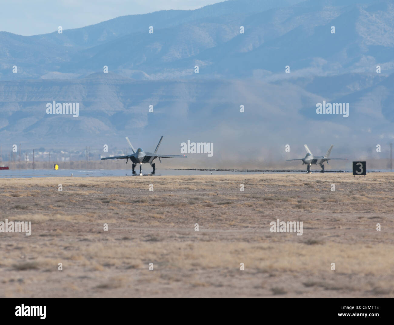 HOLLOMAN AIR FORCE BASE, N.M. - Two F-22 Raptors taxi onto the runway before a training mission Feb. 16. Holloman is home to the 7th Fighter Squadron and its fleet of F-22s. The F-22 has a combination of stealth, supercruise, maneuverability, and integrated avionics, and when coupled with improved supportability, represents an exponential leap in warfighting capabilities. Stock Photo