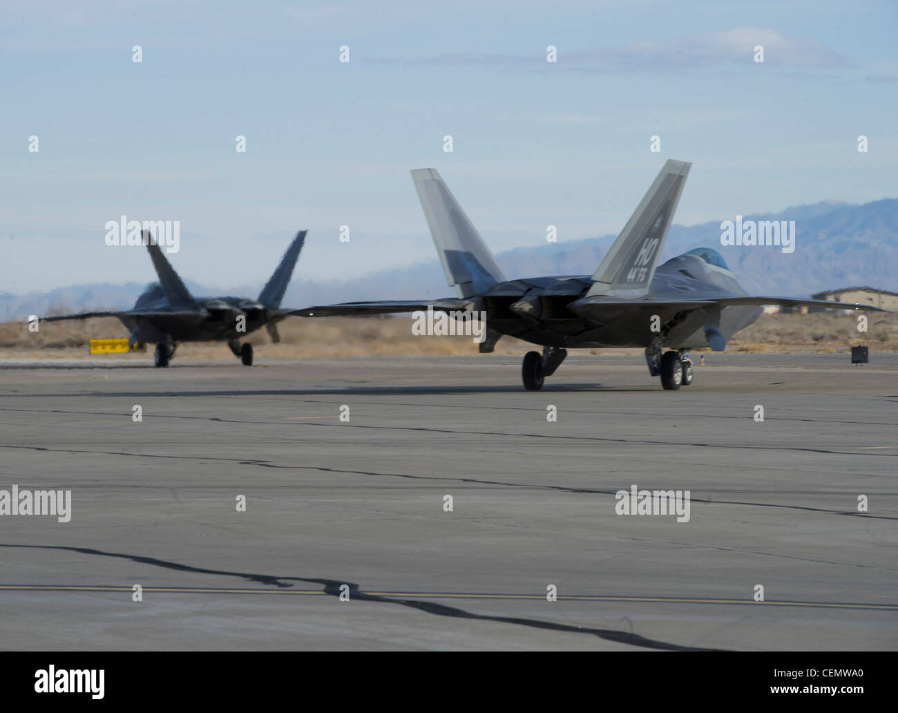 HOLLOMAN AIR FORCE BASE, N.M. -- Two F-22 Raptors taxi to the runway Feb. 16, after successfully getting through the end of runway final checks. Eight F-22s were launched as Holloman’s premiere aircraft took to the sky to continue training to maintain combat mission readiness. Stock Photo