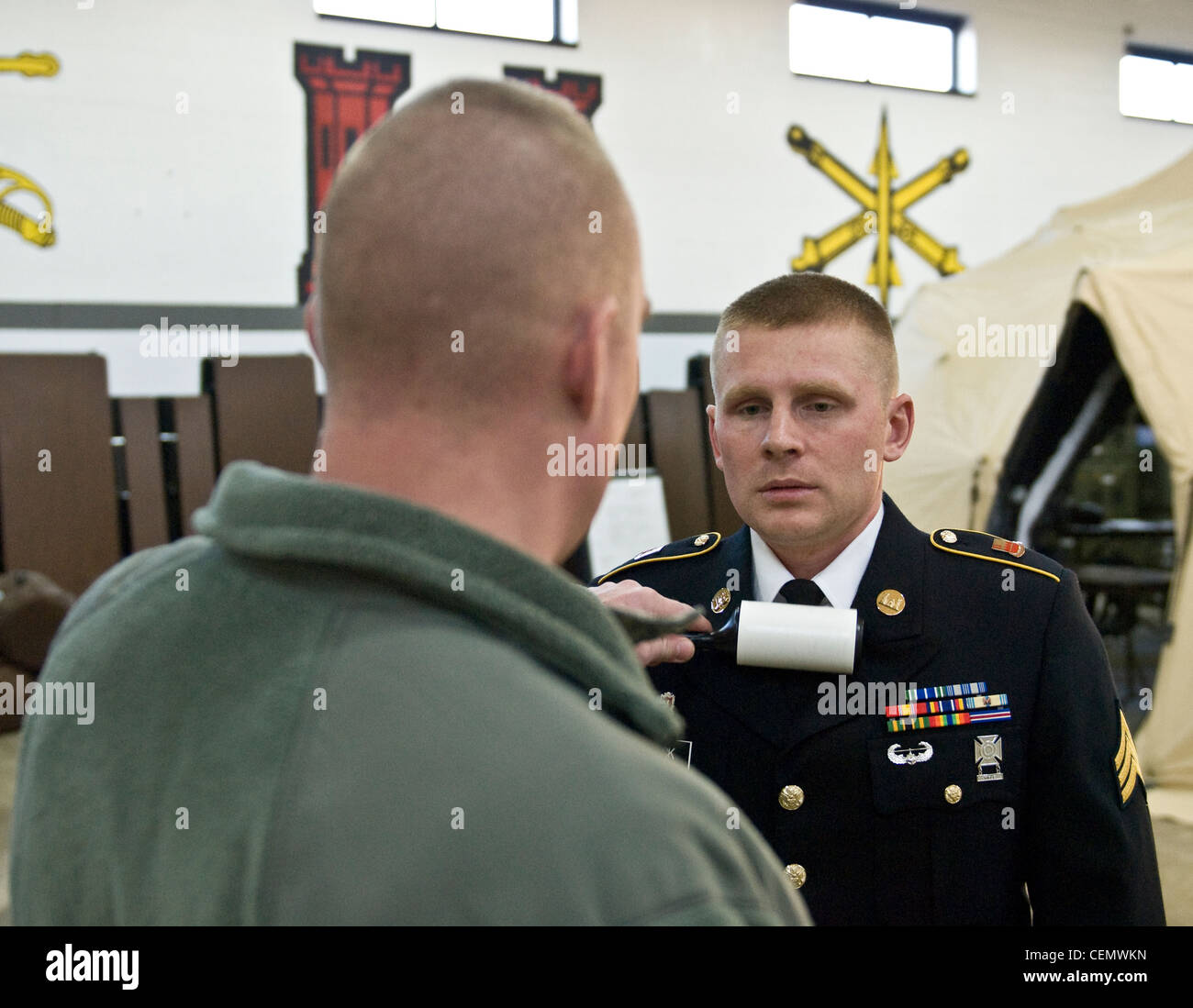 MARSEILLES, Ill.-- Sgt. Kyle Schick of Hustisford Wis., who is a Interior Electrician with the 372nd Engineer Company out of Pewaukee, Wis., gets his uniform checked over by his sponsor before his board appearance at the 2012 372nd Engineer Brigades Best Warrior Competition on Feb. 16. Stock Photo