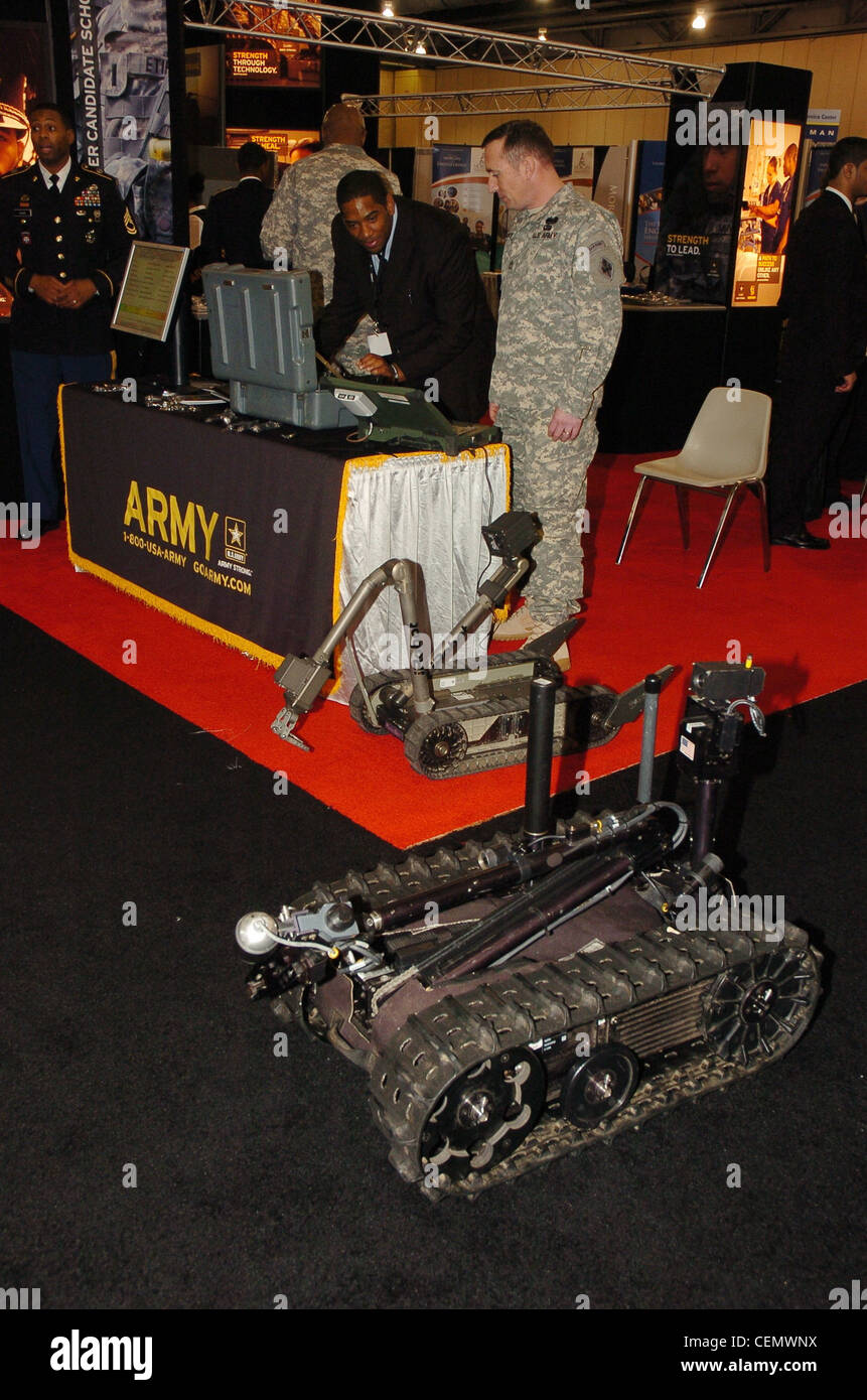 Sgt. 1st Class Todd Moyer, U.S. Army Engineer, Fort Leonard Wood, Mo., works with a student at the U.S. Army robotic display during the BEYA high tech Expo in Philadelphia, Feb. 18, 2012. Stock Photo
