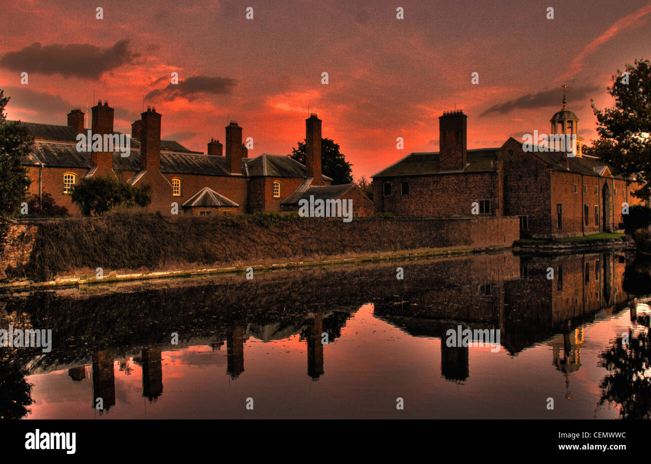 Dunham Massey NT at dusk with a red sunset sky This is National Trust near Altrincham, England UK. Its a stately home and garden Stock Photo