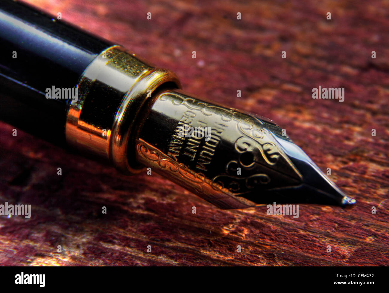 Old fashioned letter writing - Fountain pen nib on wood, macro close up using a microscope Stock Photo