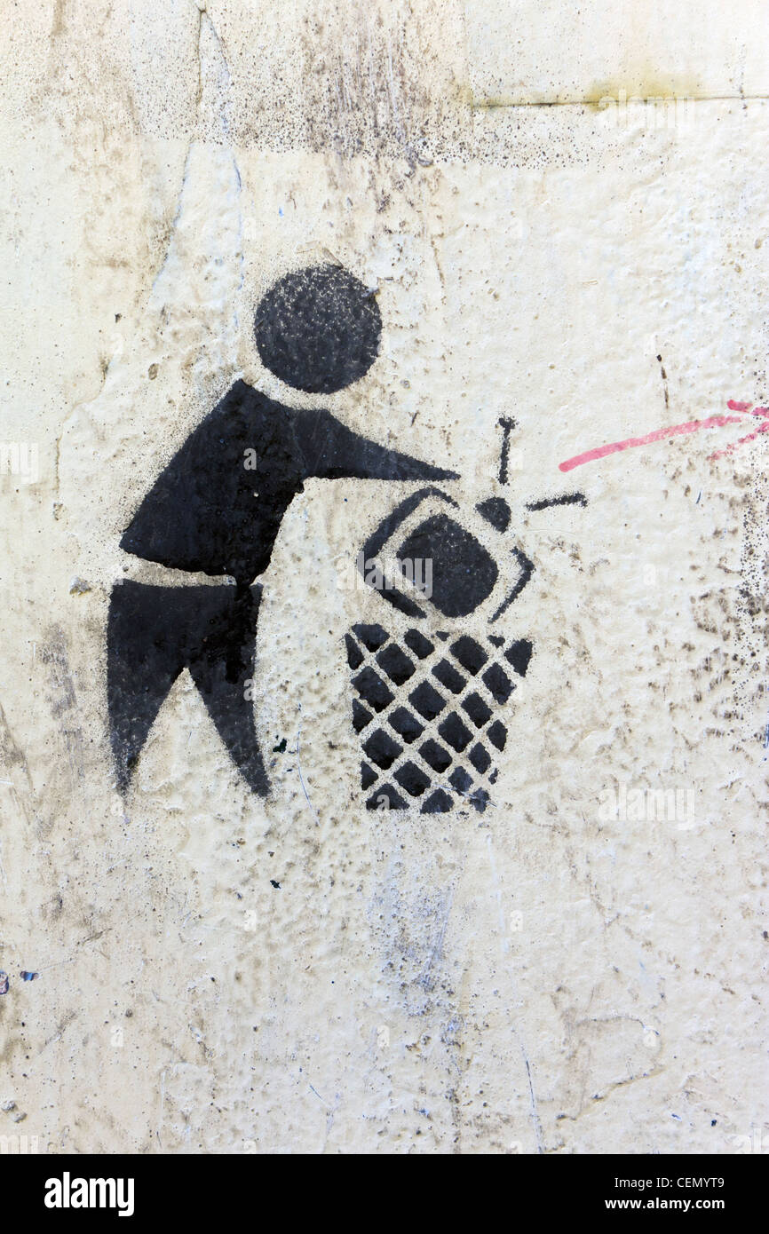 graffiti on wall near Tahrir Square, Cairo, Egypt with image of television being dumped in wastebasket Stock Photo