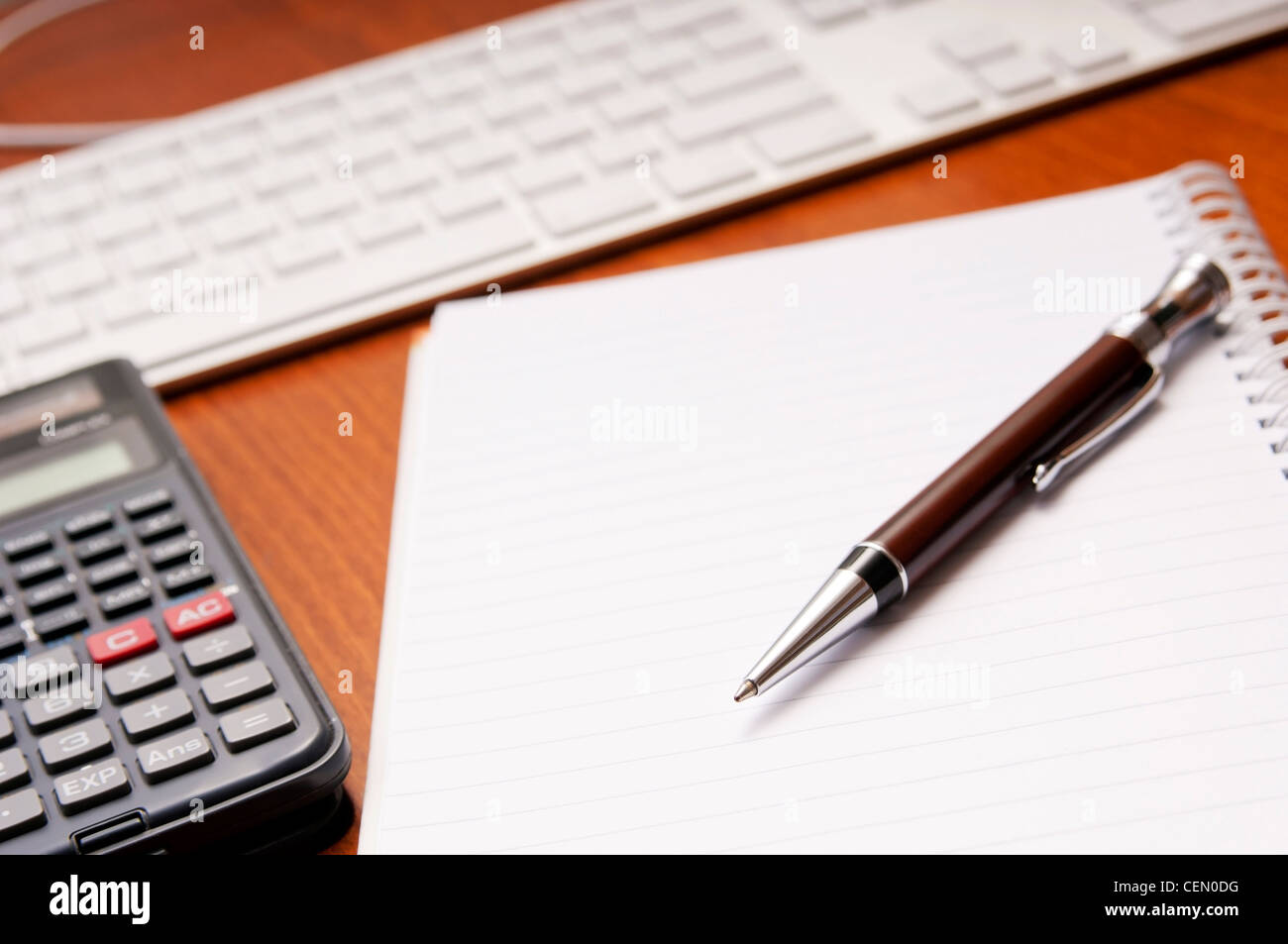 Office desk concept with pad, pen, calculator in view Stock Photo Alamy