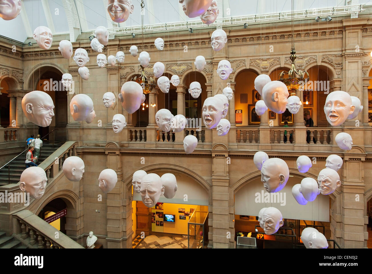 Heads on display from the ceiling of the Kelvingrove Art Gallery and Museum in Glasgow. The exhibit is Expression by Sophie Cave Stock Photo