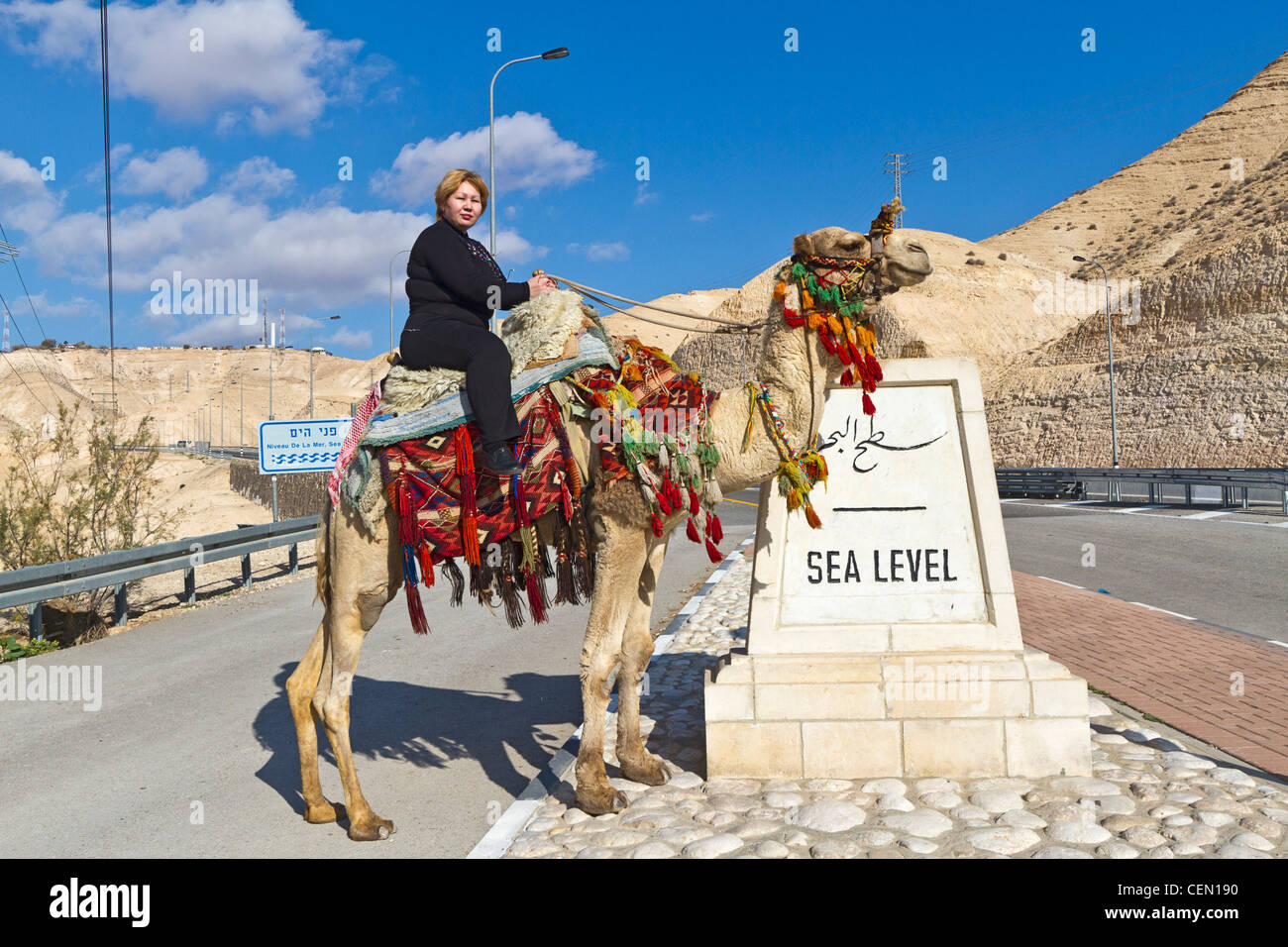 Tourist rides a camel at the 