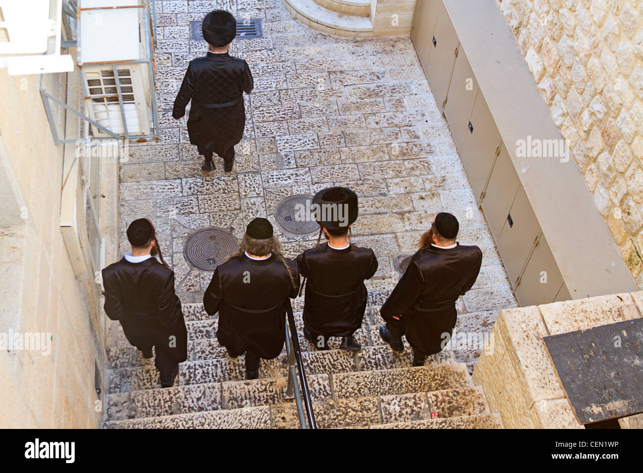 Observant Orthodox Jewish men on their way to pray at the Wailing Wall in Jerusalem, Israel. Stock Photo