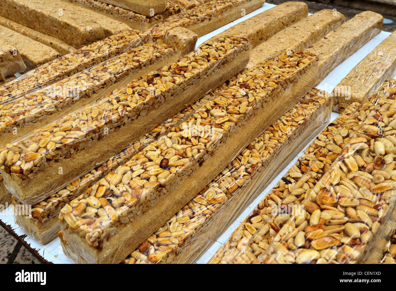 Halvah, a very sweet Middle Eastern dessert made of sesame seed paste, here topped with nuts. Stock Photo