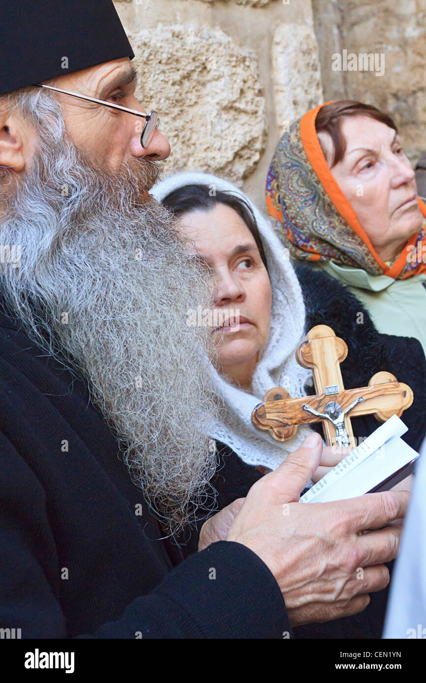 Greek Orthodox priest leads faithful people in prayer at the Church of