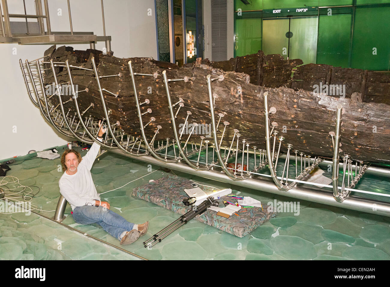 Researcher with ancient Galilee boat at the Yigal Allon Centre (Jesus