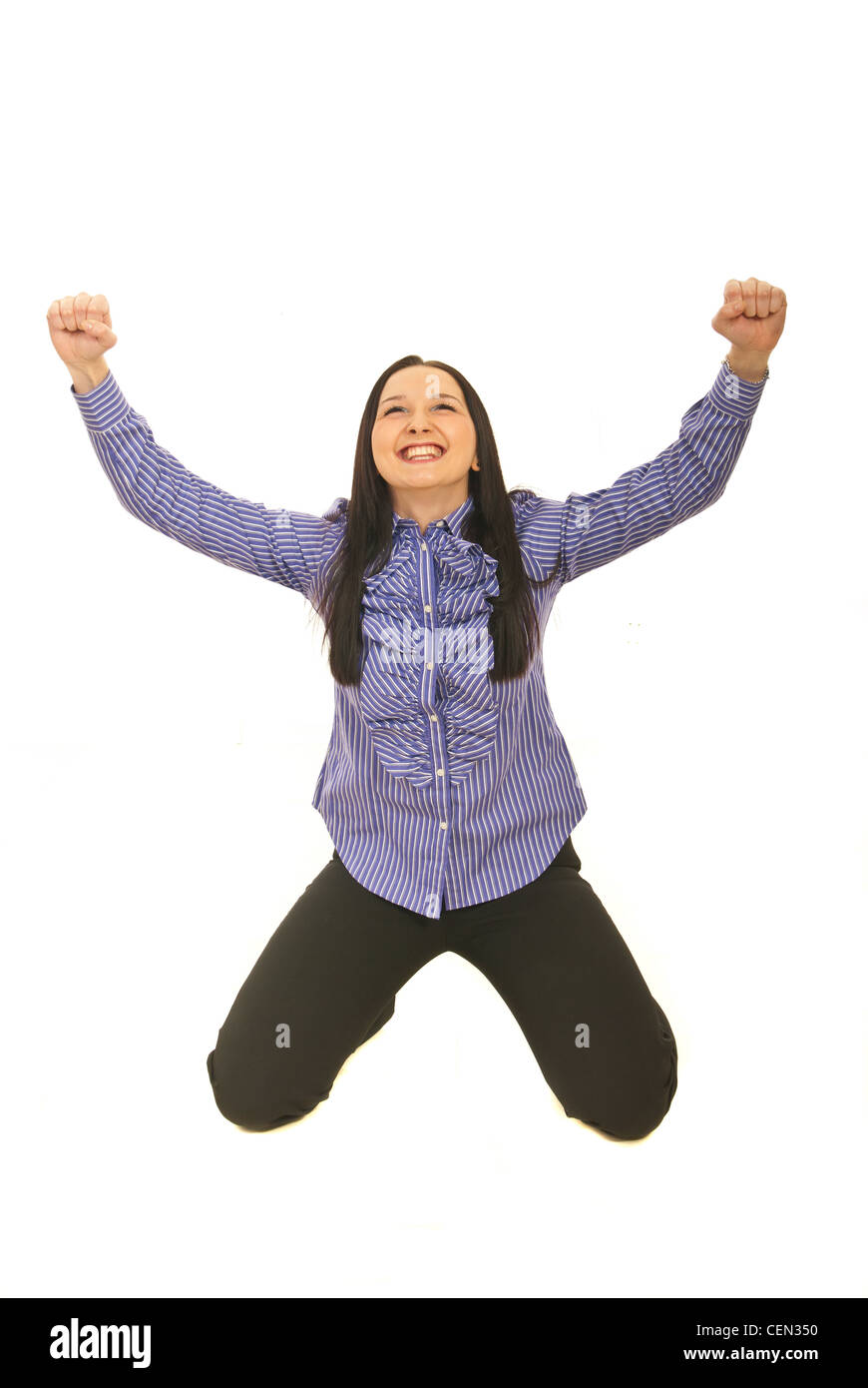 Victorious business woman sit on knees and raising her arms isolated on white background Stock Photo