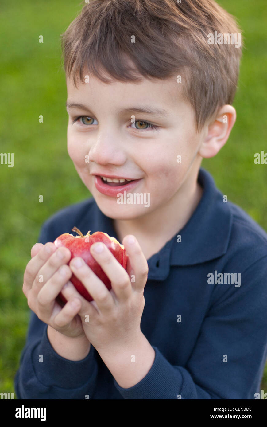 Five Year Old Boy Eating An Apple Stock Photo Alamy