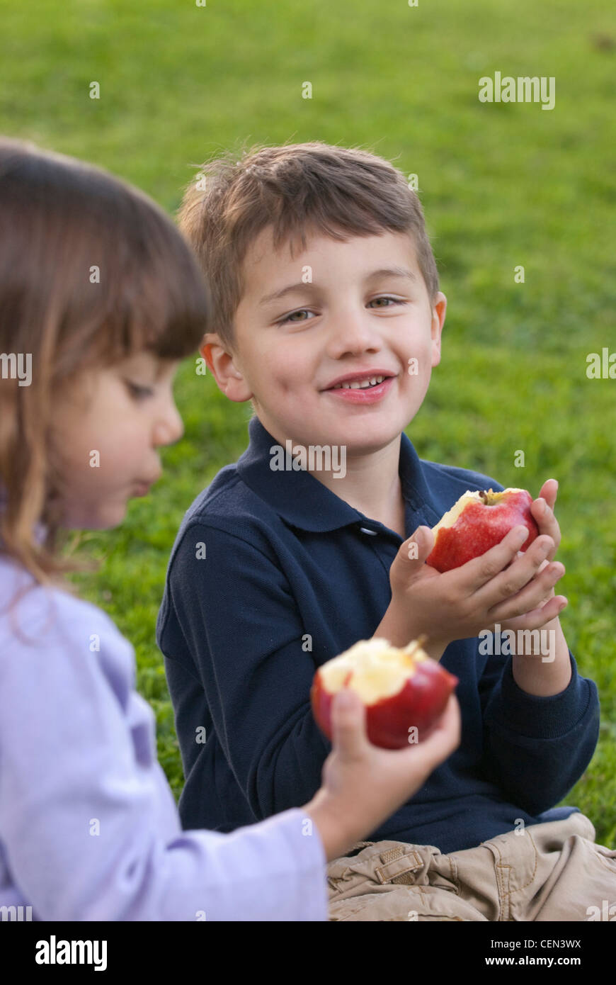 Two Children Eating Apples Stock Photo Alamy