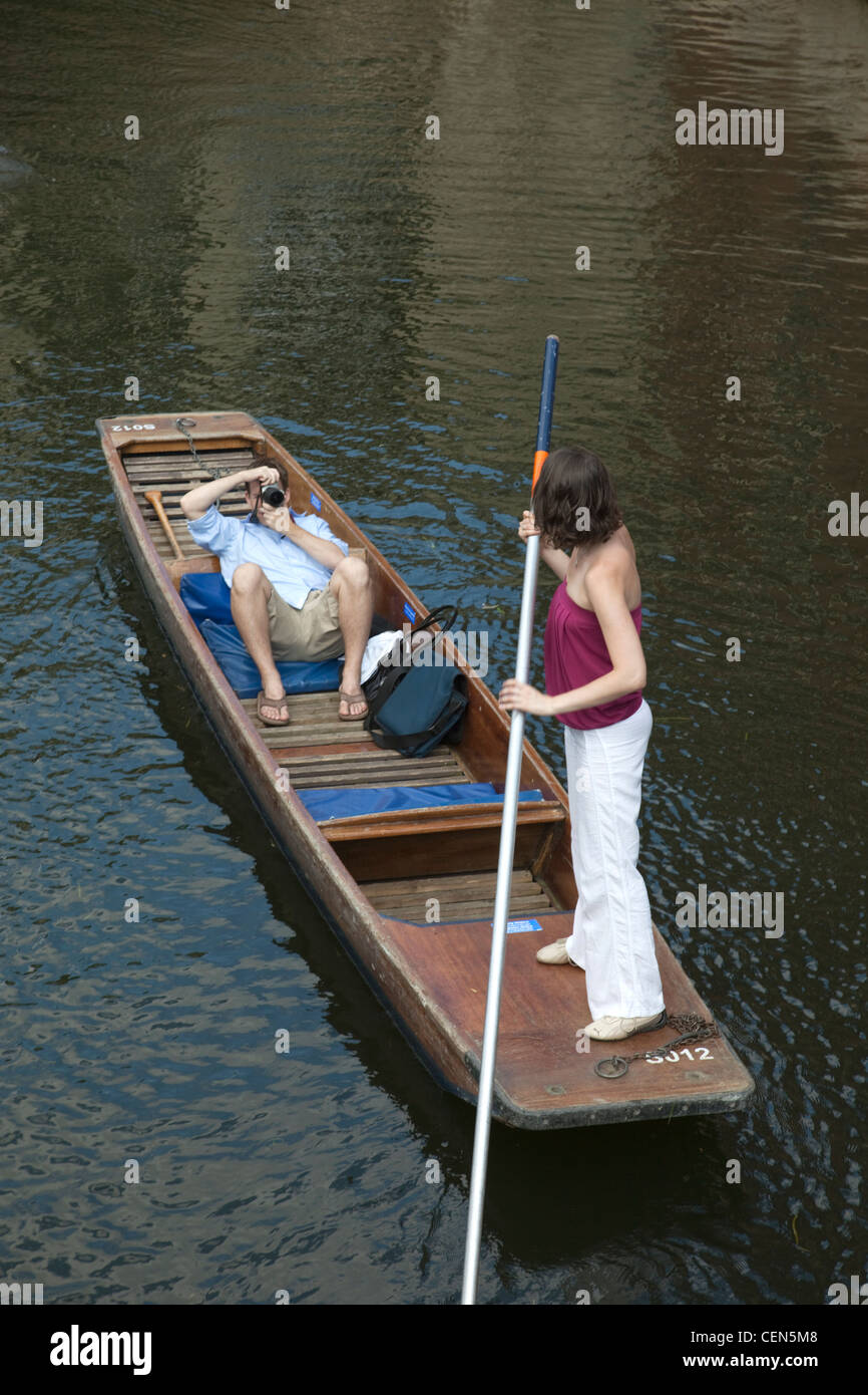 England, Cambridgeshire, Cambridge, Couple Punting on River Cam Stock Photo