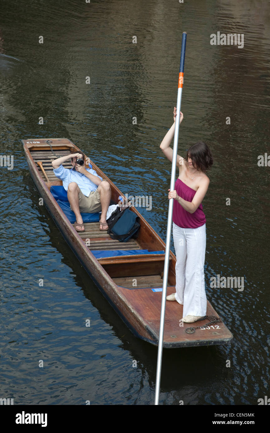 England, Cambridgeshire, Cambridge, Couple Punting on River Cam Stock Photo