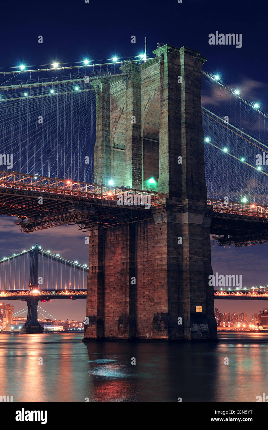 Brooklyn Bridge closeup over East River at night in New York City ...