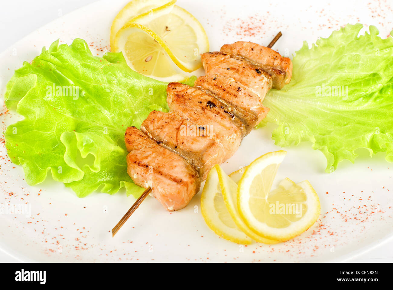 salmon kebab closeup at plate isolated on a white background Stock