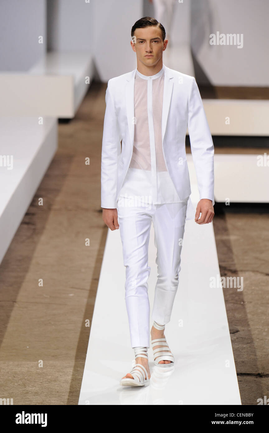 Hugo by Hugo Boss Paris Ready to Wear Spring Summer Male model wearing a  white trouser suit, see through white shirt and white Stock Photo - Alamy