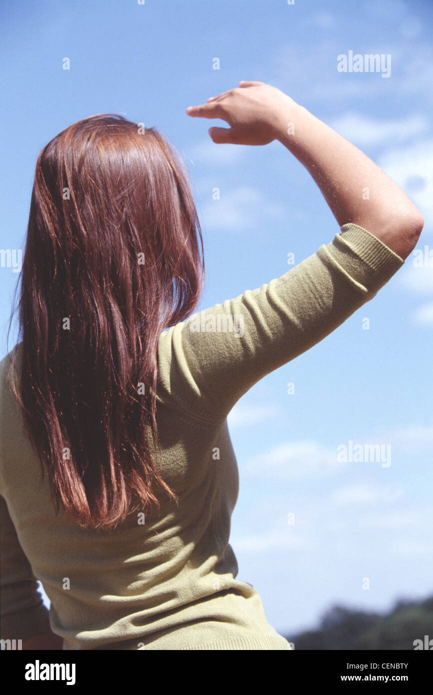 Back View Of Female With Long Brunette Hair Wearing Green Top One