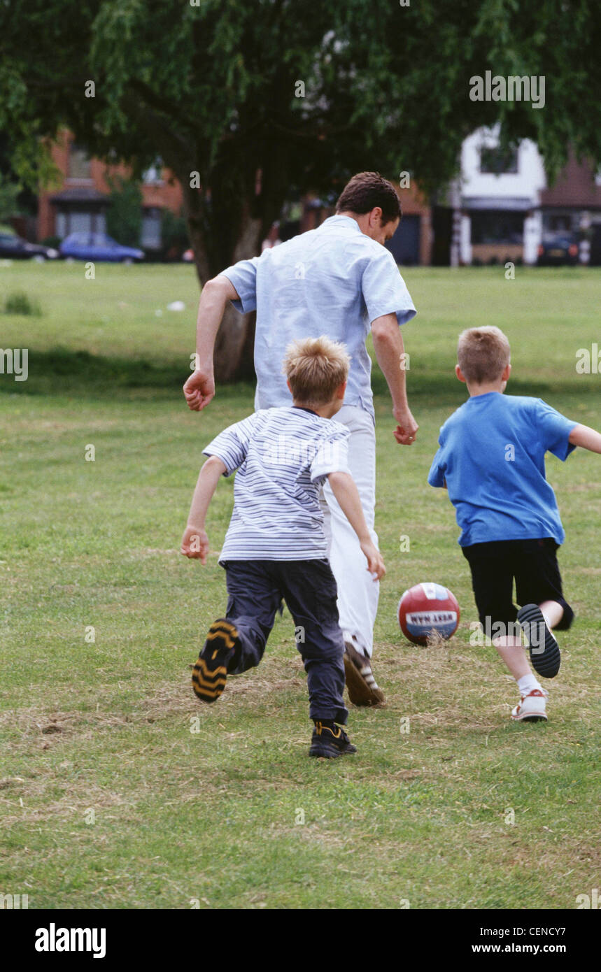 Male short brown hair playing football in park two male children blonde hair running towards ball away from camera Stock Photo - Alamy Male short brown hair playing football in park two male children blonde hair running towards ball away from camera Stock Photo - Alamy