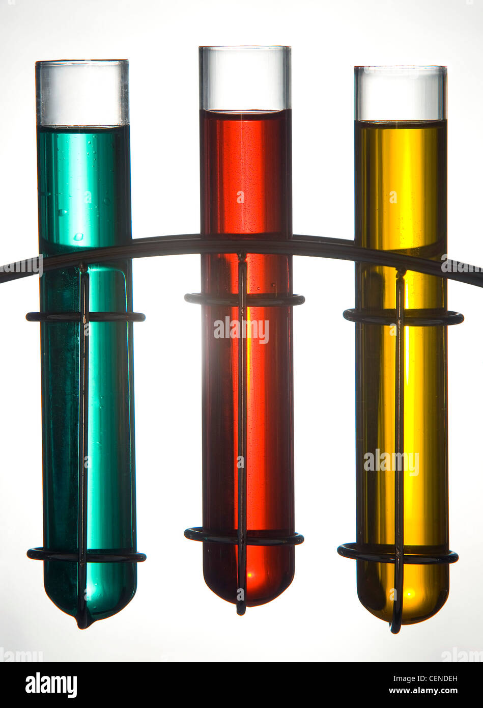 Generic blue, red and yellow liquid in glass test tubes in a chrome stand Stock Photo