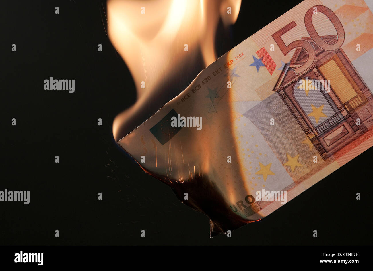 burning money on black background Stock Photo