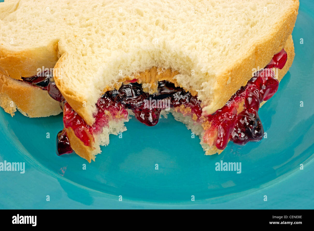 Close View Peanut Butter And Jelly Sandwich On White Bread Bitten Stock Photo Alamy