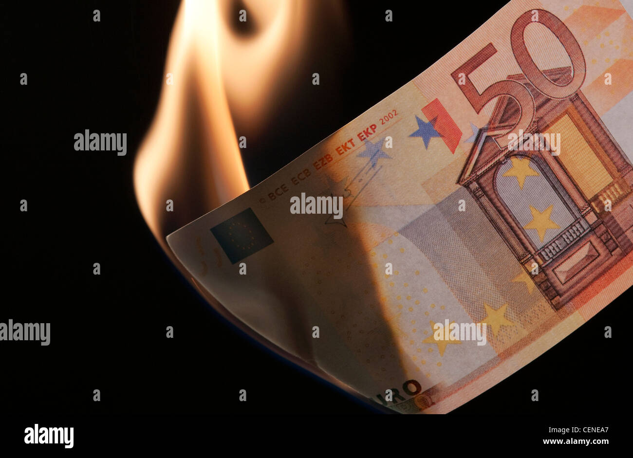 burning money on black background Stock Photo