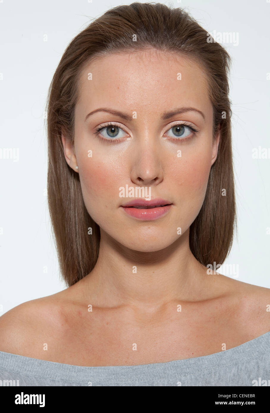 Female fair hair off her face, wearing a grey off the shoulder top, peachy blusher, pearly eyeshadow and clear lipgloss, Stock Photo